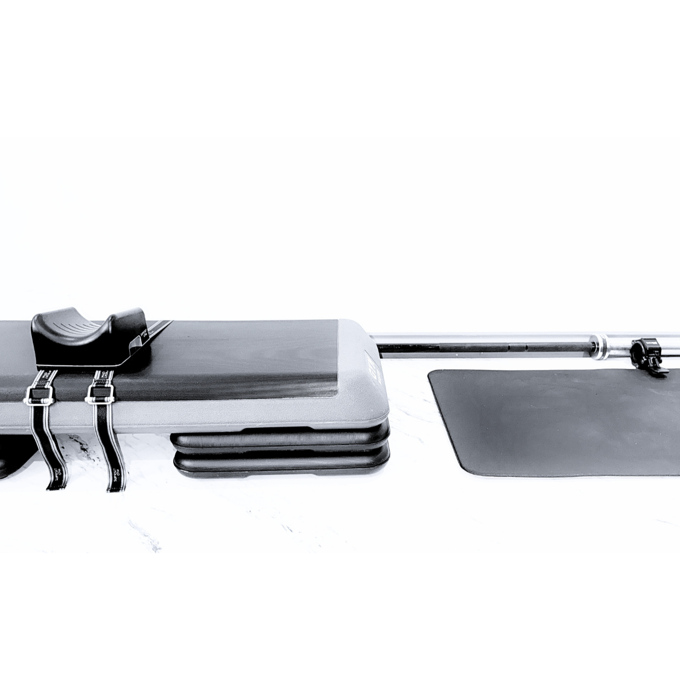 Bulgarian split squat anchor installed to aerobic steppers with a mat and a barbell. 